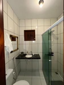 a bathroom with a sink and a toilet and a shower at Rota do Mar in Luis Correia +41 photos
