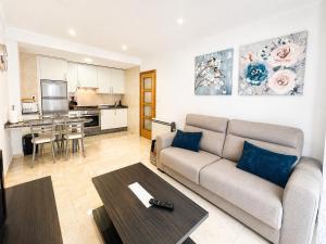 a living room with a couch and a table at Apartamento TIERRA in Viveiro