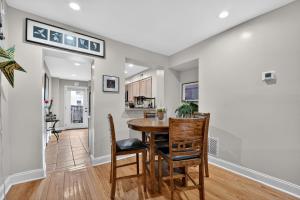 a dining room and kitchen with a table and chairs at Baltimore premier townhouse in Baltimore