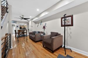 a living room with two couches and a table at Baltimore premier townhouse in Baltimore