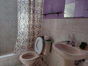 a bathroom with a toilet and a sink at Depa Huancayo in Huancayo