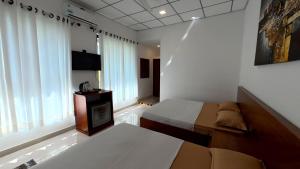 a bedroom with a bed and a fireplace in it at Sewana Cottage in Kurunegala