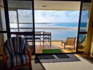 a room with a balcony with a view of the ocean at Gemini Unit 64 Golden Beach QLD in Golden Beach