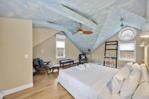 a bedroom with a white bed and a ceiling with a sky at 3 Bedroom Cape House by Leavetown Vacations in Sandwich