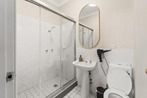 a bathroom with a shower and a toilet and a sink at Olympic Paddington Budget Hotel - across Allianz Stadium in Sydney +13 photos