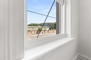 an open window with a view of a street at Olympic Paddington Budget Hotel - across Allianz Stadium in Sydney