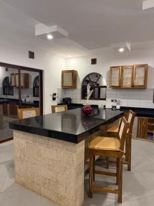 a kitchen with a large island with a counter top at Villa marina in Mombasa