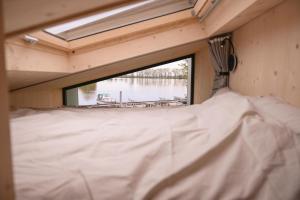 a view from the inside of a trailer with a window at Tiny House Nook 3 - Green&Tiny Hideaway Eider in Süderstapel
