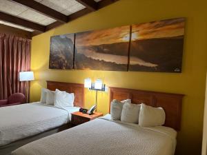 a hotel room with two beds and a telephone at Days Inn by Wyndham Niles in Niles