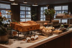 a display of bread and pastries on a table at Home Hotel With in Tromsø