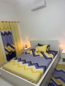 a bedroom with a large bed with yellow and blue pillows at Little friend #1 Two balconies,elevator in Boca Chica +33 photos