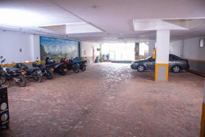 a parking lot with motorcycles parked in a parking garage at Hotel BENNY Los Leones Melgar in Melgar