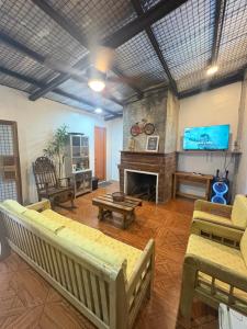 a living room with a fireplace and a tv at Cloudrest Marilog in Kayagan