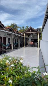 a patio of a house with tables and chairs at Romance in Bay in Arugam Bay