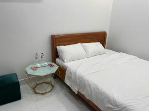 a bedroom with a bed and a side table at Home Me 1 in Dong Hoi