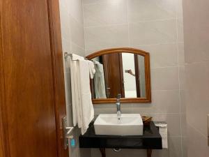 a bathroom with a sink and a mirror at Home Me 1 in Dong Hoi +2 photos