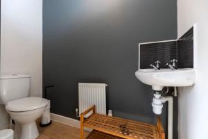 a bathroom with a sink and a toilet at Spacious 3BR Durham Home Contractor Friendly in Durham +15 photos