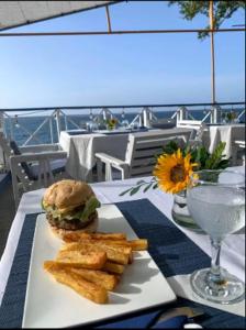 a plate with a sandwich and french fries on a table at The Rocks Villa in Tower Isle