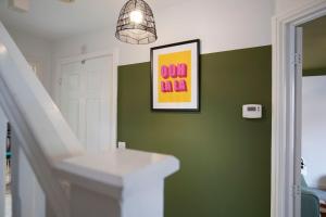 a bathroom with a white sink and green walls at Stylish Durham 3-Bed Comfort Long Stays in Spennymoor +29 photos