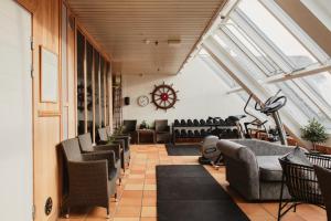 a living room with skylights and chairs and tables at Home Hotel With in Tromsø