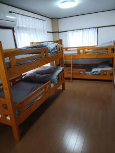 a room with three bunk beds in it at ゲストハウスMoana 那珂湊おさかな市場徒歩5分,9名可,BBQ可 in Hitachinaka +60 photos