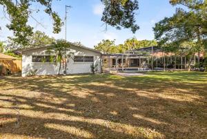 an empty yard in front of a house at Spacious Clearwater House 4BR 3BA Private Pool in Clearwater