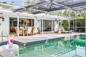 a house with a swimming pool and a patio at Spacious Clearwater House 4BR 3BA Private Pool in Clearwater