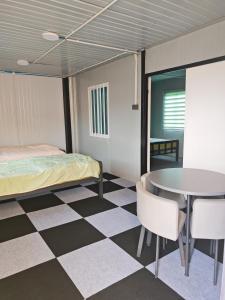 a room with a bed and a table at deLotus Villa in Simpang