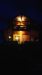 a building with lights on top of it at night at Chalé dos ventos in Itamonte