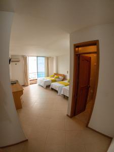 a view of a room with two beds in it at Hotel BENNY Los Leones Melgar in Melgar