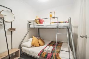 a bedroom with a bunk bed with a ladder at Carrington Views - 3 Bedrooms - CBD - Parking in Adelaide