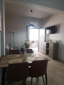 a kitchen and dining room with a table and chairs at Buganvilla Sea View apts in Agia Pelagia