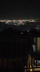 a view of a city at night with lights at Aura by bala in Dehradun