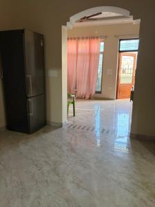 an empty room with a refrigerator in a room at Aura by bala in Dehradun
