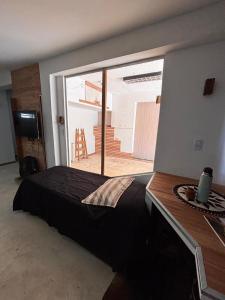 a bedroom with a bed with a large window at Loft in La Rioja