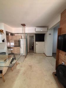 a kitchen with a glass table and a refrigerator at Loft in La Rioja