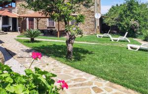 a garden with pink flowers and a stone pathway at Awesome Apartment In Castellabate Sa in Castellabate