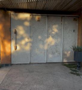 a pair of white doors on a building at monoambiente huellas2 in La Rioja