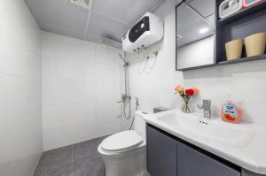 a white bathroom with a toilet and a sink at LAN HA PEARL HOTEl in Phù Long +22 photos