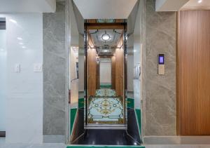 a hallway with a staircase in a building at LAN HA PEARL HOTEl in Phù Long