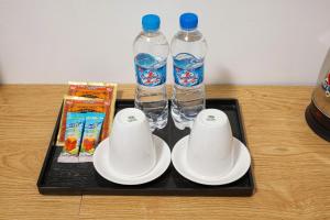 a tray with two cups and two bottles of water at LAN HA PEARL HOTEl in Phù Long