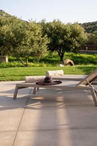 a bench sitting on a sidewalk in a park at Vedema Homes in Lefkogeia