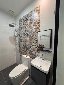 a bathroom with a toilet and a sink at Tdoze Hotel At Piccadilly Ipoh in Ipoh