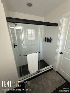 a shower with a glass door with a towel at Casa Blanca in Irving +58 photos