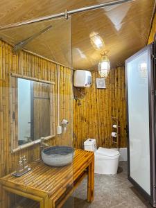 a bathroom with a sink and a toilet at Om Tara Retreat in Yên Bái