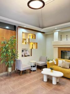 a living room with a yellow couch and a table at Yuhum Bed & Breakfast - Mandalagan in Bacolod