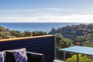 a view of the ocean from the balcony of a house at Hekerua Heights with Hot Tub and Seaviews in Oneroa