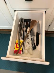 a drawer filled with knives and other kitchen utensils at Casa Goiaba in Piçarras