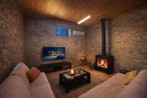 a living room with a couch and a fireplace at Angel's House in Alcobaça
