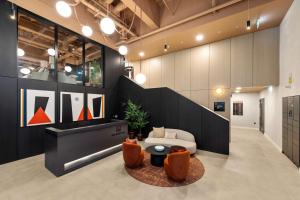 a lobby with a couch and a table and chairs at Apex Executive Apartments - The Ironworks in Dublin